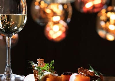 A plate with food and a glass of wine in the restaurant of the Glacier Lagoon hotel