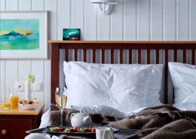 Inside a Rangá hotel room, bed and breakfast tray