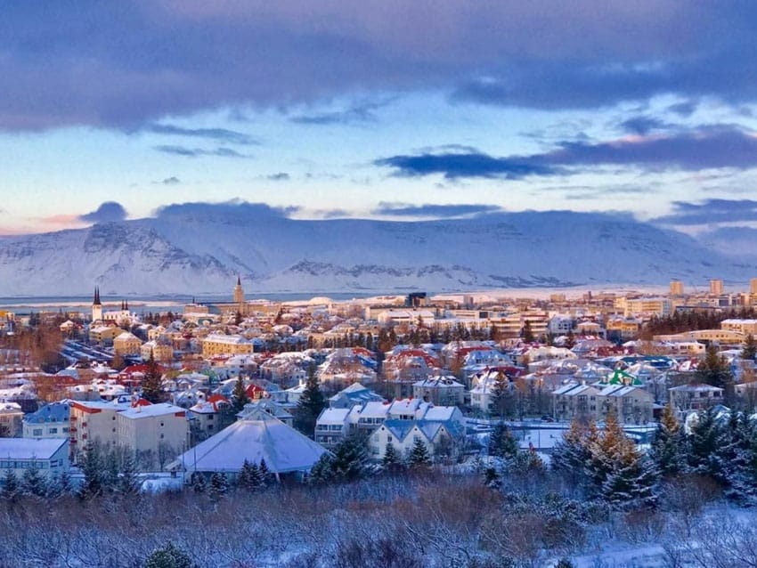 City view of Reykjavík at dusk with snow mountain background